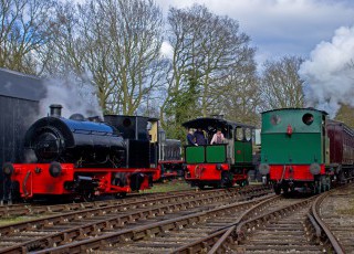 Bagnal_Works_No_2565_and_Cockerill_Tram_2525_pause_as_they_go_on_shed,_as_Wissington_runs_into_the_station_with_the_train_on_the_MSLR_during_the_Easter_Steam_up_event_on_6-4-15_Lawrie_Rose.jpg